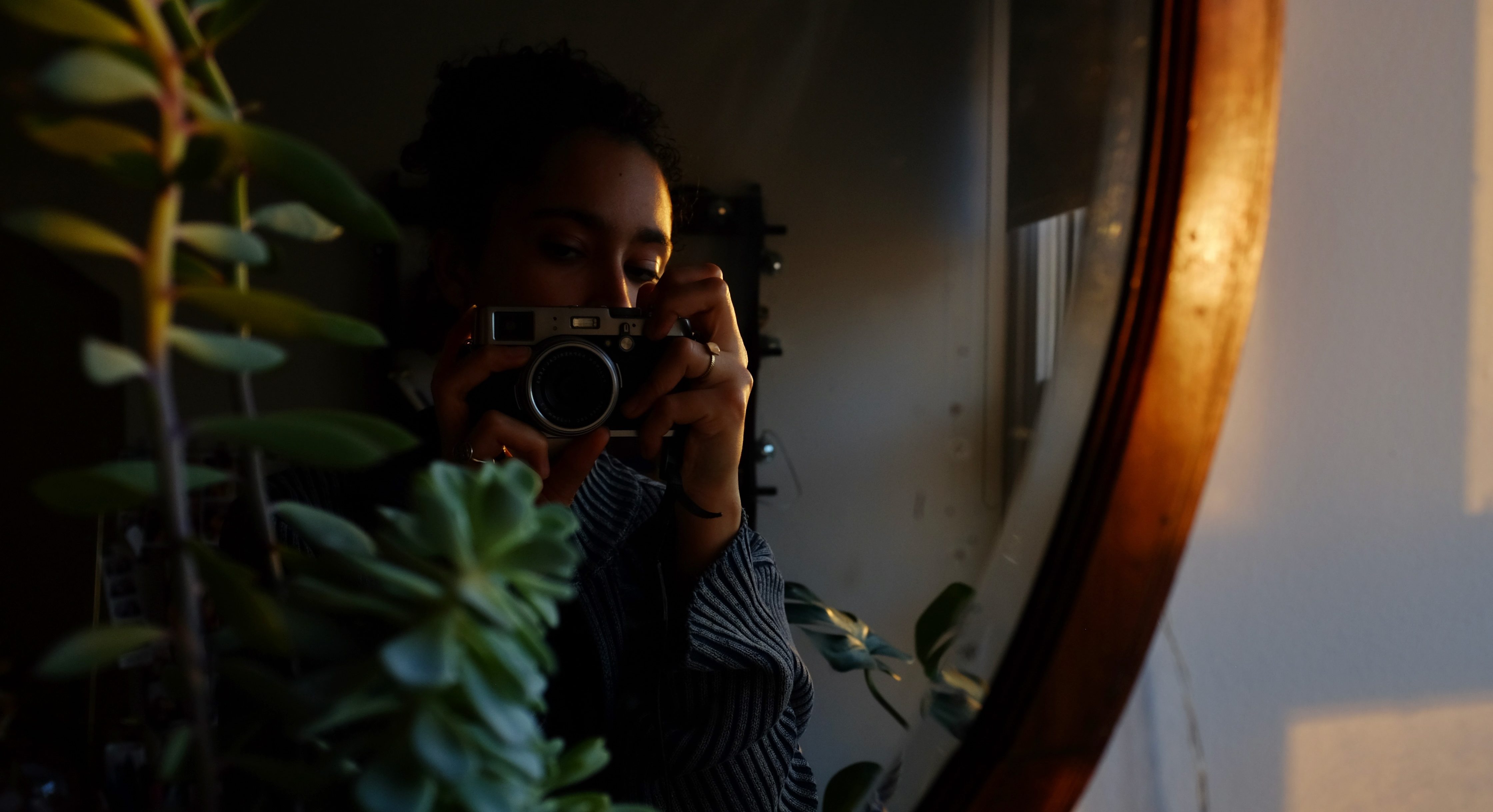 Mirror self-portrait of Savannah Acquah in warm tones